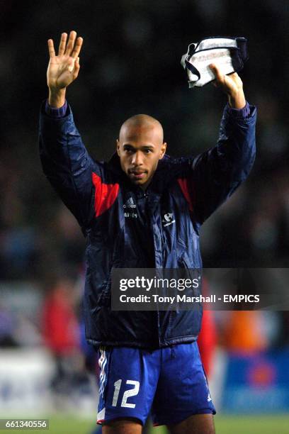 France's Thierry Henry applauds the travelling fans at the end of the game