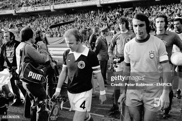 The two captains, Scotland's Billy Bremner and Brazil's Piazza , lead their teams out before the match, followed by their goalkeepers, Scotland's...