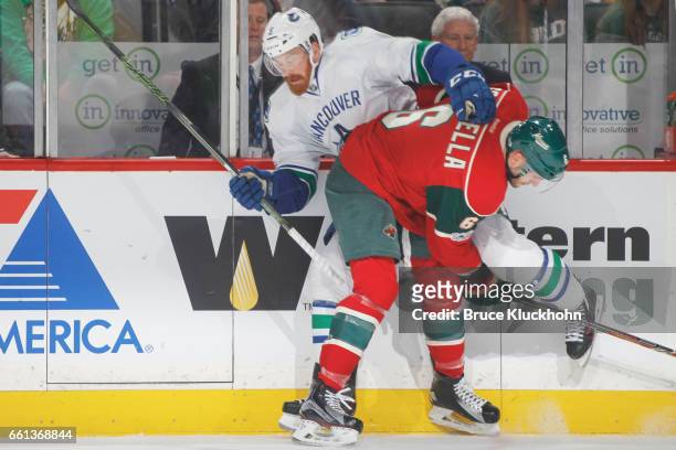 Marco Scandella of the Minnesota Wild checks Jack Skille of the Vancouver Canucks during the game on March 25, 2017 at the Xcel Energy Center in St....