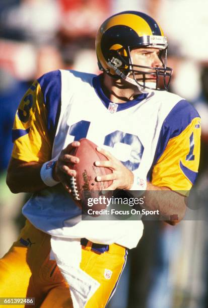 Kurt Warner of the St. Louis Rams drops back to pass against the San Francisco 49ers during an NFL football game November 21, 1999 at Candlestick...