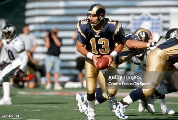 Kurt Warner of the St. Louis Rams turns to handoff to a running back against the Philadelphia Eagles during an NFL football game September 9, 2001 at...
