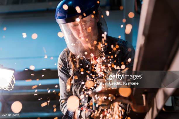 female using angle grinder in workshop - blue collar worker mask stock pictures, royalty-free photos & images