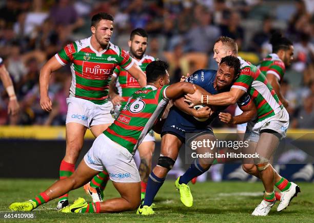 Patrick Kaufusi of the Cowboys is tackled by Zane Musgrove and Jason Clark of the Rabbitohs during the round five NRL match between the North...