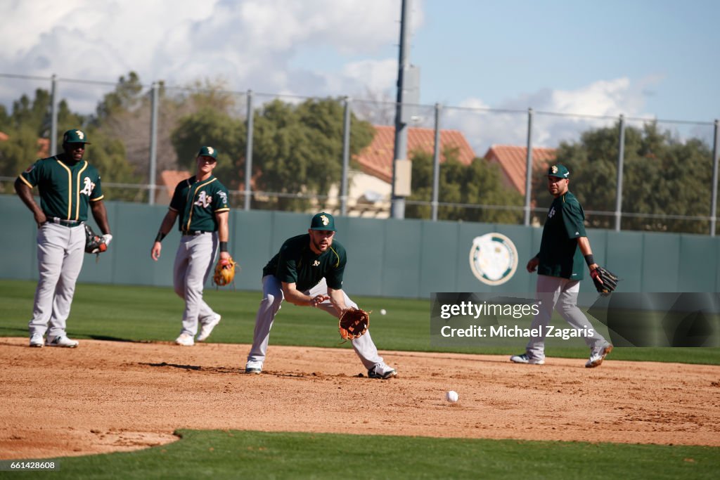 Trevor Plouffe of the Oakland Athletics goes through infielder drills ...