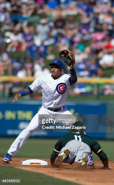 Rajai Davis of the Oakland Athletics steals second as Addison Russell of the Chicago Cubs takes a late throw during a game at Solan Park on February...