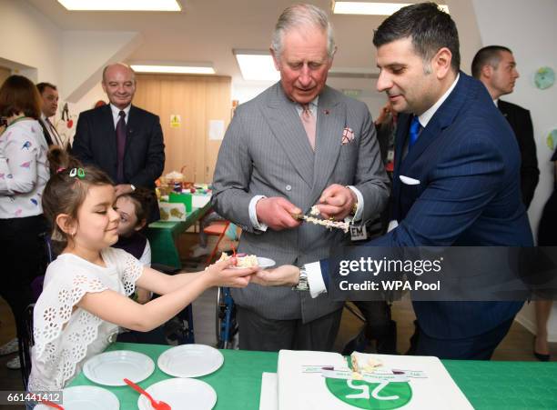 Prince Charles, Prince of Wales cuts the 25th anniversary cake while visiting Hospices of Hope on the third day of his nine day European tour on...