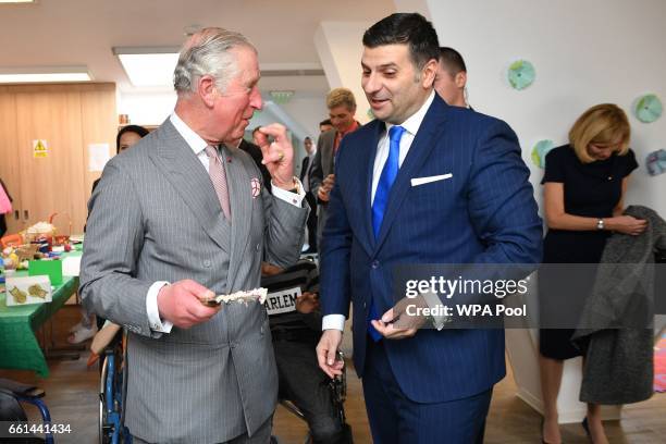 Prince Charles, Prince of Wales cuts the 25th anniversary cake while visiting Hospices of Hope on the third day of his nine day European tour on...