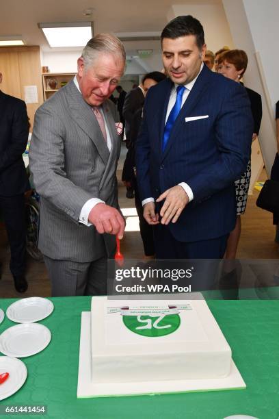 Prince Charles, Prince of Wales cuts the 25th anniversary cake while visiting Hospices of Hope on the third day of his nine day European tour on...