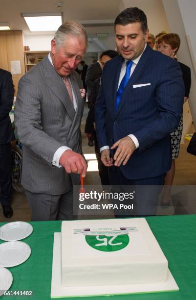 Prince Charles, Prince of Wales cuts the 25th anniversary cake while visiting Hospices of Hope on the third day of his nine day European tour on...