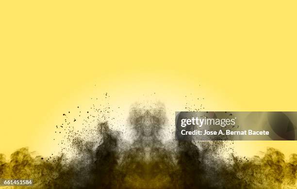 blackground of particles of gray powder in ascending movement floating in the air produced by an impact - etéreo stock pictures, royalty-free photos & images