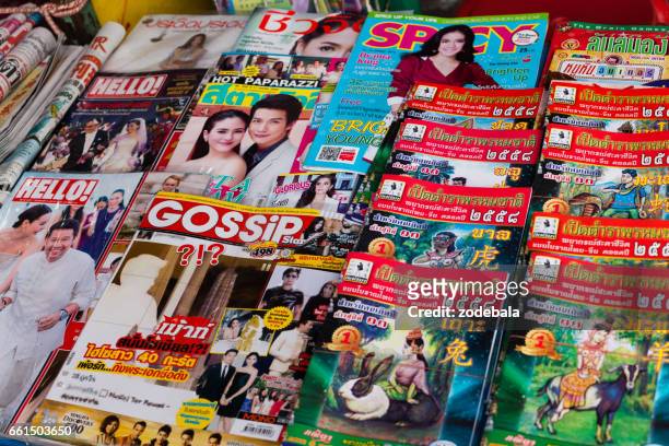thailand magazines displayed for sale on newsstand - thailandia stock pictures, royalty-free photos & images