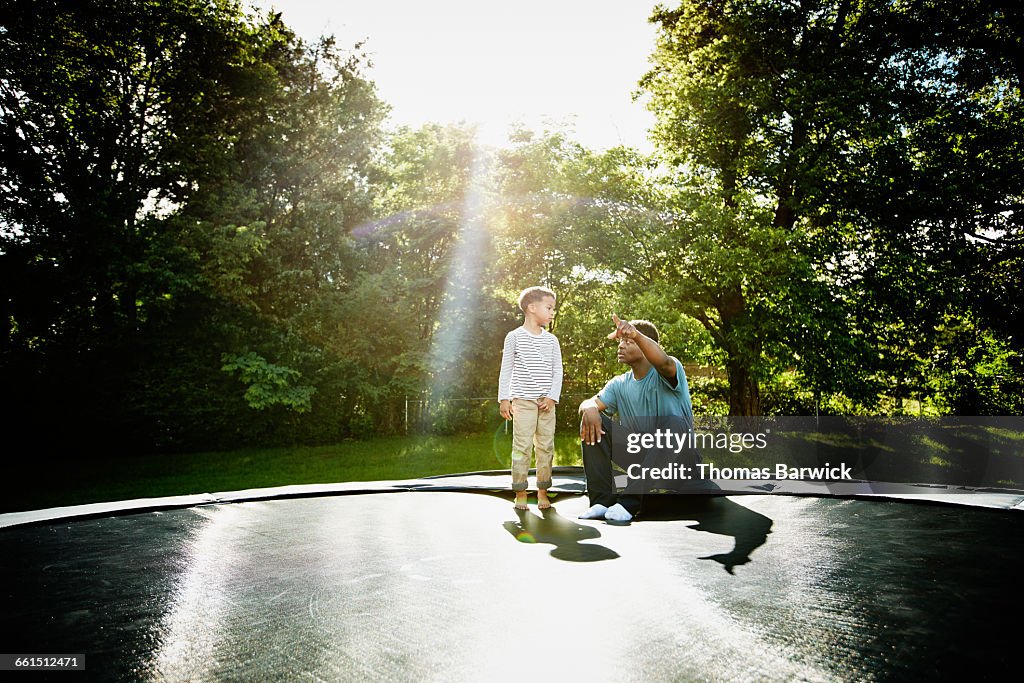 Father with young son on trampoline