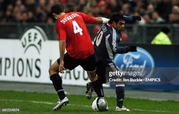 Benfica's Fabrizio Miccoli is challenged by Lille's Efstathios Tavlaridis