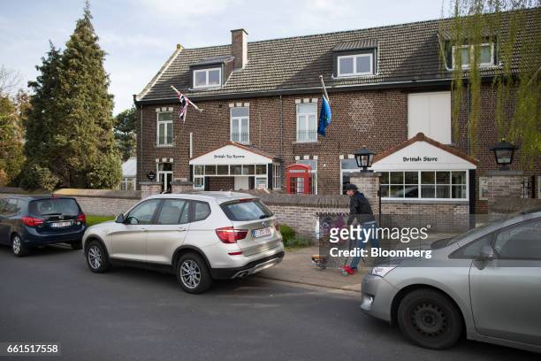 Shopper wheels goods to his car outside the Stonemanor British Store in Kortenberg, Belgium, on Friday, March 31, 2017. U.K. Prime Minister Theresa...