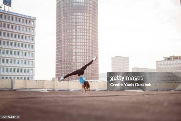 female ballet dancer dancing on a rooftop in lyon, france - collant ストックフォトと画像