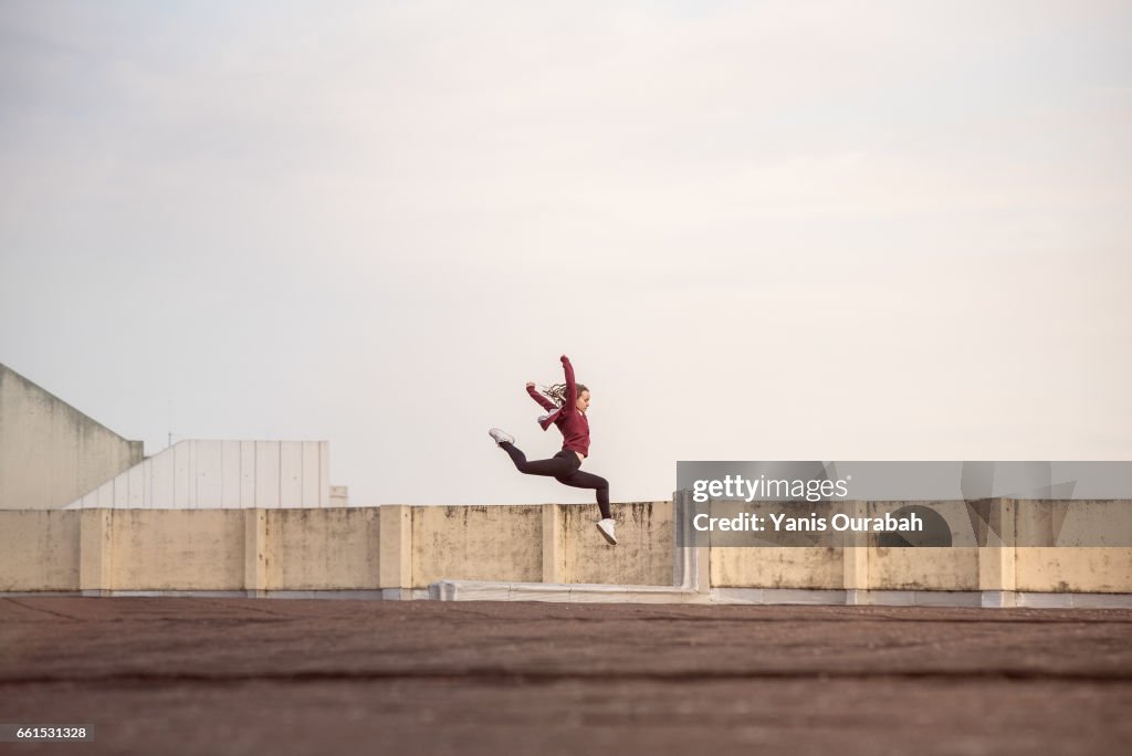 Female ballet dancer dancing on a rooftop in Lyon, France
