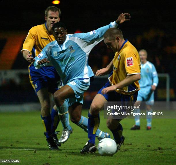 Mansfield Town's Jon Olav Hjelde and Jake Buxton and Grays Athletic's Dennis Oli