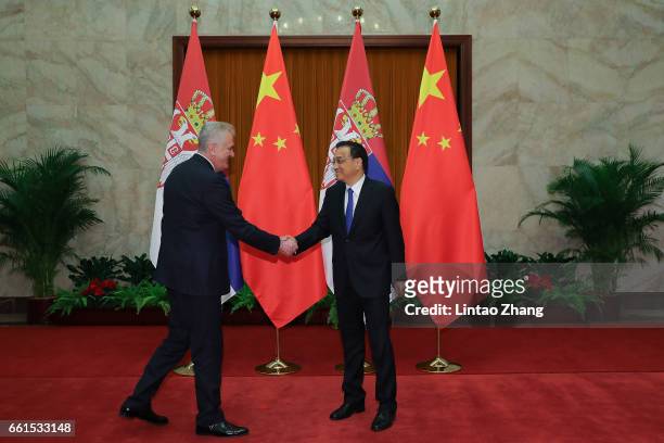 Chinese Premier Li Keqiang shakes hands with Serbian President Tomislav Nikolic at the Great Hall of People on March 31, 2017 in Beijing, China. At...