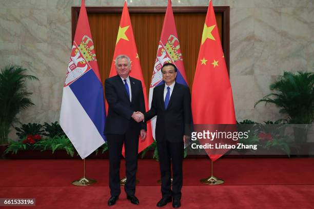 Chinese Premier Li Keqiang shakes hands with Serbian President Tomislav Nikolic at the Great Hall of People on March 31, 2017 in Beijing, China. At...