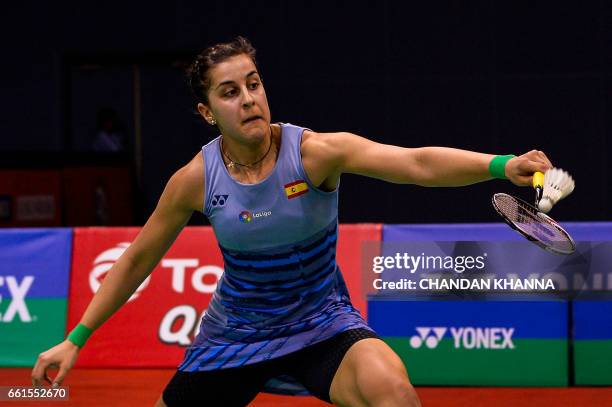 Carolina Marin of Spain returns a shot against Minatsu Mitani of Japan during the women's single badminton match at the Yonex-Sunrise India Open 2017...