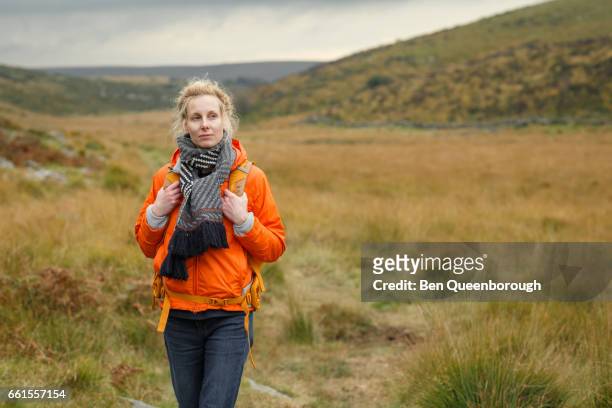woman hiking in a national park - devon stock pictures, royalty-free photos & images