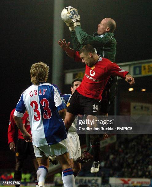Blackburn Rovers' goalkeeper Brad Friedel clashes with Manchester United's Alan Smith