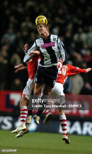 West Bromwich Albion's Martin Albrechtsen wins a header from Charlton Athletic's Alexei Smertin and Bryan Hughes