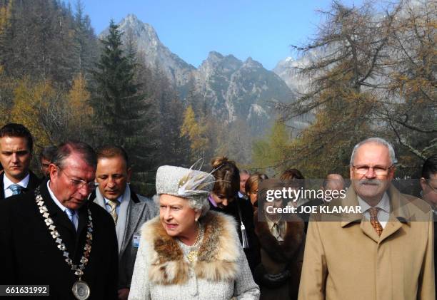 Queen Elizabeth II is accompanied by Slovak President Ivan Gasparovic and Mayor of Vysoke Tatry Jan Mokos during their trip to the Hrebienok ski...