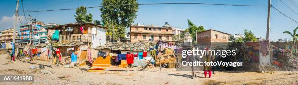 kathmandu families outside shacks colourful laundry beside bagmati river nepal - smelly laundry stock pictures, royalty-free photos & images