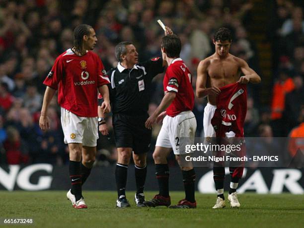 Referee Alan Wiley shows a yellow card to Manchester United's Cristiano Ronaldo after he removed his shirt during a goal celebration