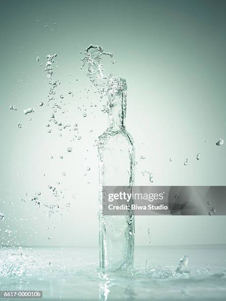 water splashing from bottle - pure foto e immagini stock