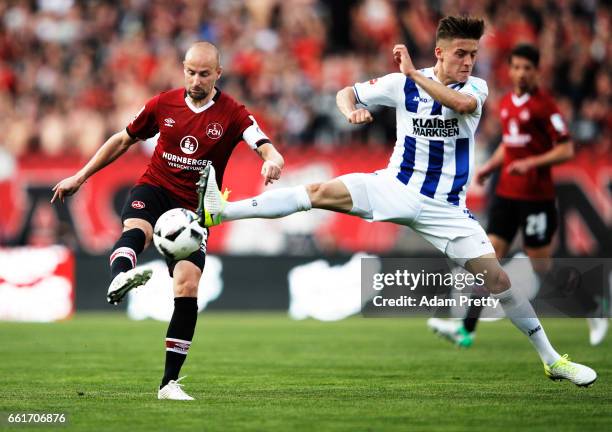 Miso Brecko of 1.FC Nuernberg is challenged by Marvin Mehlem of Karlsruher SC during the Second Bundesliga match between 1. FC Nuernberg and...