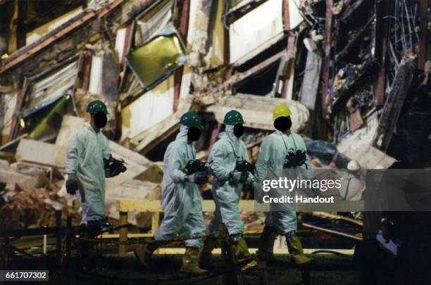 In this handout provided by the Federal Bureau of Investigation , emergency responders survey the damage on scene following an attack at the Pentagon...