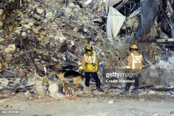 In this handout provided by the Federal Bureau of Investigation , emergency responders survey the damage on scene following an attack at the Pentagon...