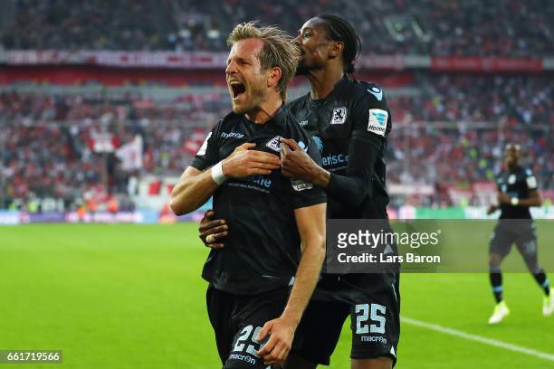 Stefan Aigner of 1860 Muenchen celebrates his team's first goal with team mate Abdoulaye Ba during the Second Bundesliga match between Fortuna...