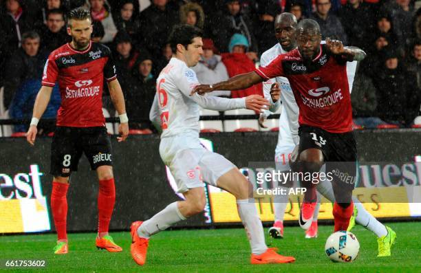 Guingamp's French forward Yannis Salibur vies with Nancy's French defender Vincent Muratori during the French L1 football match Guingamp against...
