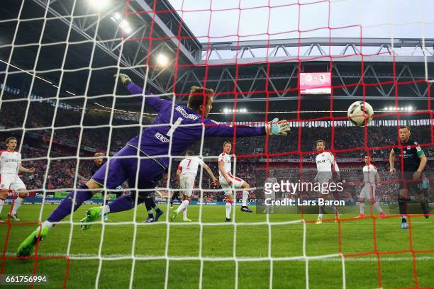 Stefan Aigner of 1860 Muenchen scores his team's first goal past goalkeeper Michael Rensing of Duesseldorf during the Second Bundesliga match between...