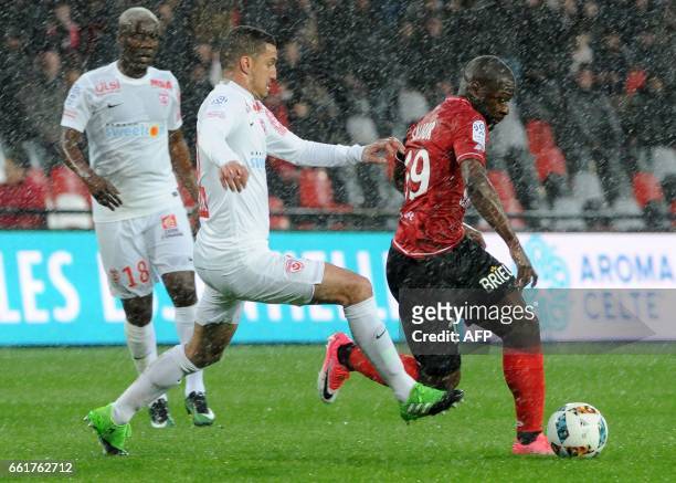 Guingamp's French forward Yannis Salibur vies with Nancy's Morrocan forward Youssouf Hadji and Nancy's Mauritanian midfielder Dialo Guidileye during...