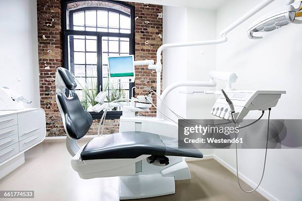 treatment room of a dental surgery - zahnarztpraxis stock-fotos und bilder