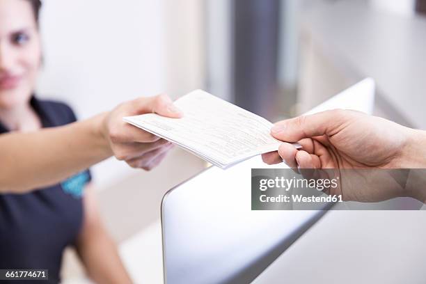 receptionist handing prescription to patient - moneytransfer stock pictures, royalty-free photos & images