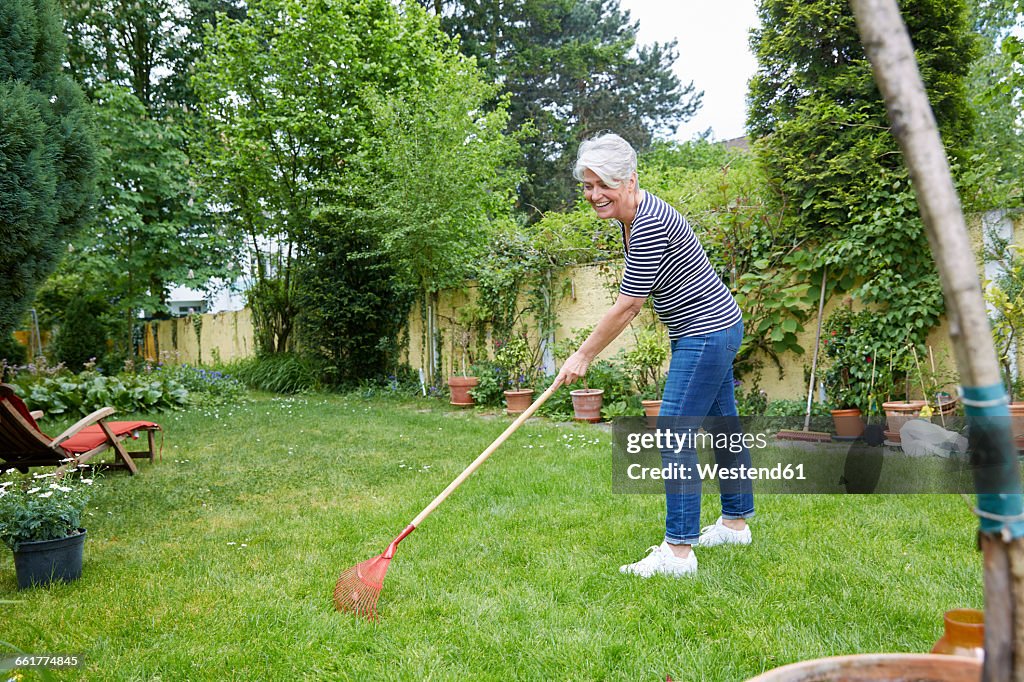 Woman Racking Lawn Woman Raking On Meadow In The Garden High-Res Stock Photo - Getty Images