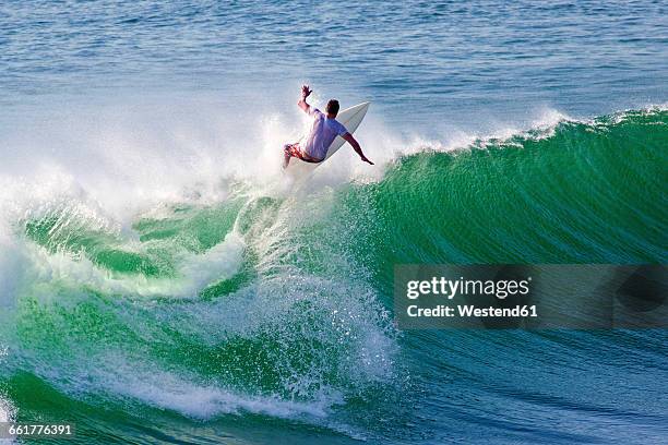 indonesia, bali, surfer on wave - indonesia surfing imagens e fotografias de stock