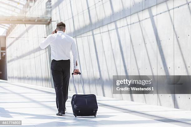 businessman with luggage and cell phone on the move - wheeled luggage 個照片及圖片檔