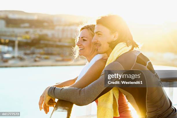 happy couple standing on deck of a cruise liner looking at distance - cruise liner ストックフォトと画像