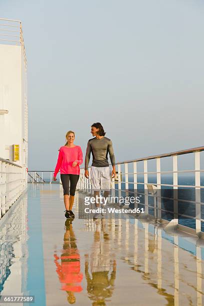 couple walking in the morning light on a shipdeck, cruise ship, mediterranean sea - passenger train stockfoto's en -beelden