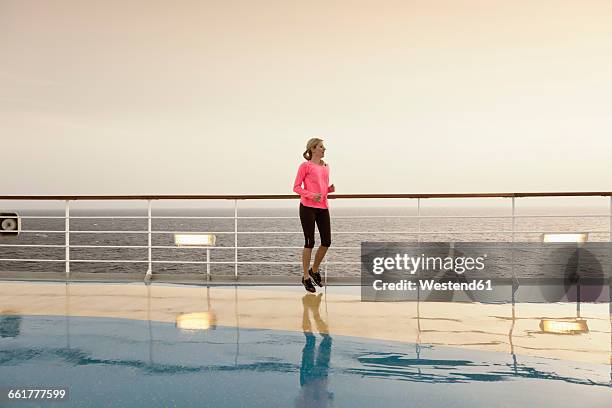 young woman doing exercises on a shipdeck, cruise ship, mediteranean sea - passenger train stockfoto's en -beelden