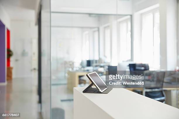 interior of bright modern office with digital tablet on ledger - focus on foreground stock pictures, royalty-free photos & images