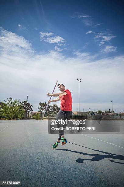 man throwing javelin in sports ground - speer stock-fotos und bilder