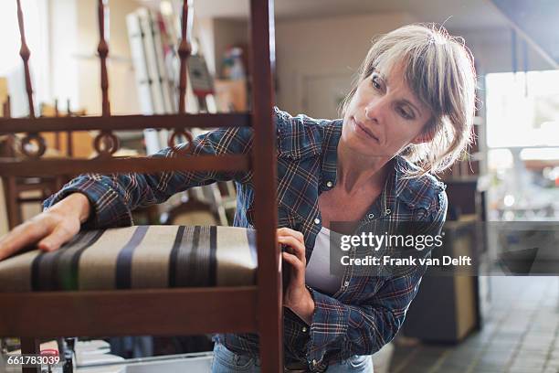 woman in workshop examining chair - upholstery worker stock pictures, royalty-free photos & images