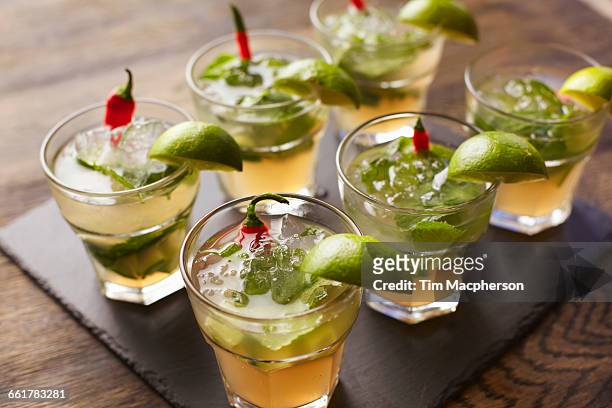 chilli vodka cocktail garnished with lime wedges - vodka stock pictures, royalty-free photos & images